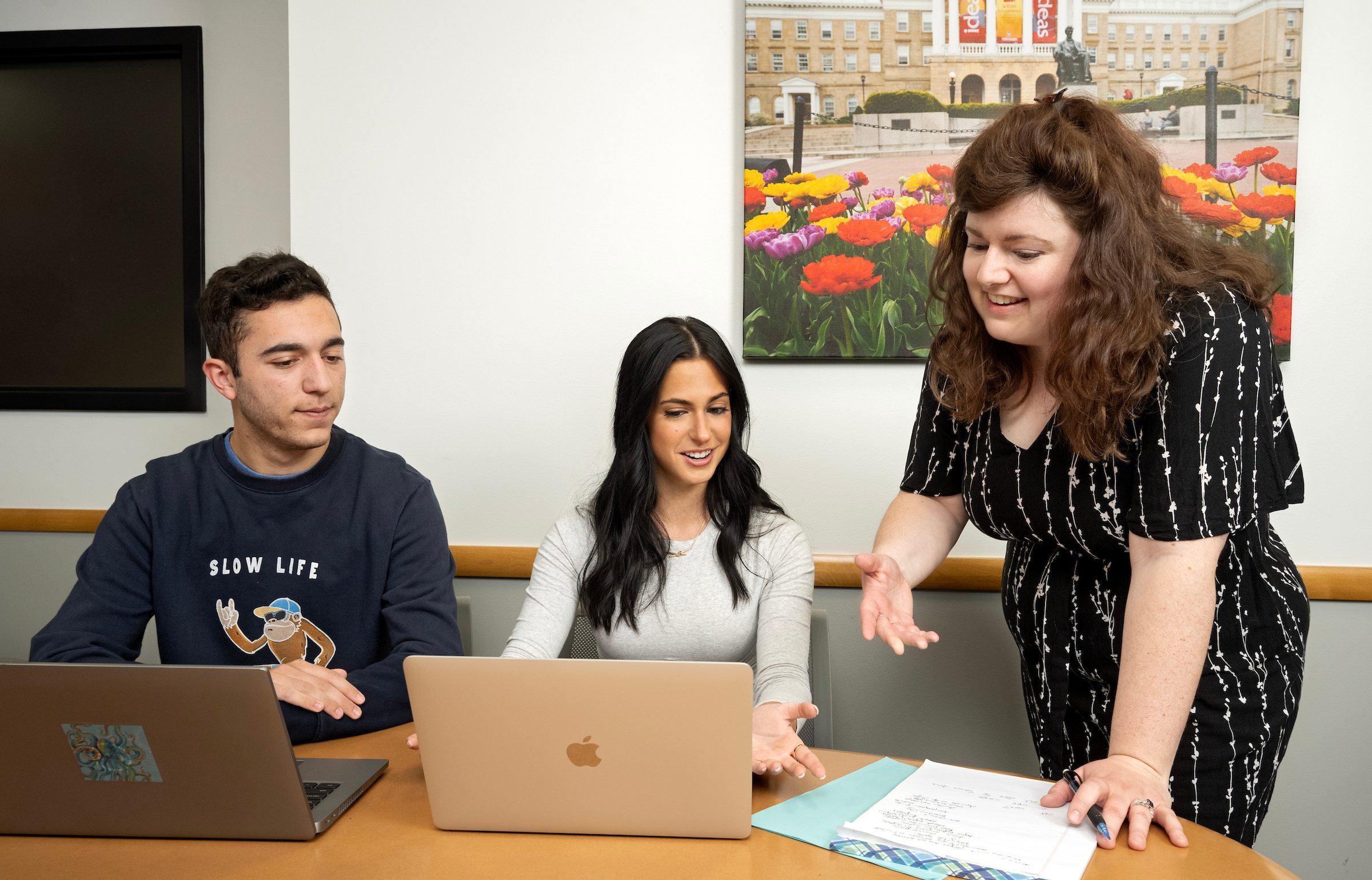 A PWL coach working with two undergraduate students.