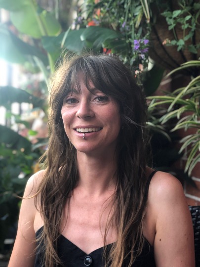 an image Dominique standing in a garden