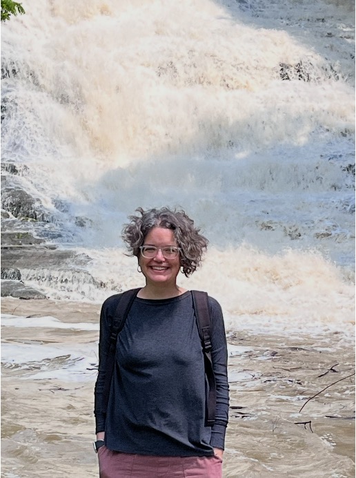 an image of Amanda in front of a waterfall